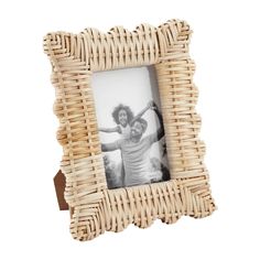 a wicker photo frame with an image of two people in the middle and one holding their arms up