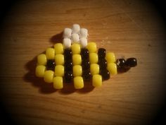 the corn cob is made out of small candy sticks and black, yellow, and white marshmallows