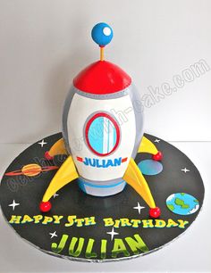 a birthday cake made to look like a rocket ship with the name julian on it