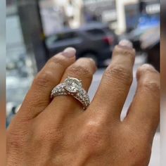 a woman's hand with a diamond ring on it