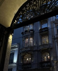 a building with many windows and balconies lit up at night