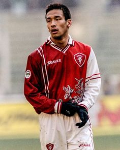 a soccer player is standing on the field