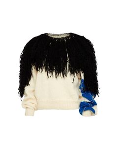 a white sweater with black and blue feathers on the front, sitting against a white background