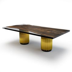 a wooden table with gold colored legs and a glass top on an isolated white background