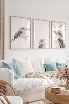 a living room with wicker furniture and paintings on the wall