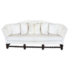 a white couch with four pillows on it