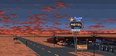 a motel sign sitting on the side of a road next to a parking lot at sunset