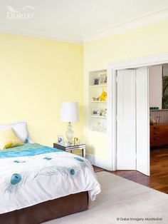 a bedroom with yellow walls and white carpeted flooring is pictured in this image