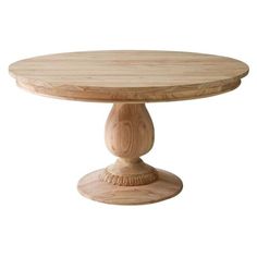 a round wooden table sitting on top of a white floor