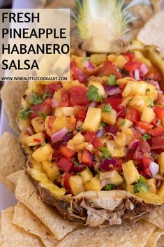 a pineapple with salsa and tortilla chips