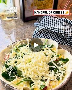 a bowl filled with pasta and cheese on top of a counter