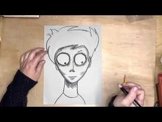 someone is drawing a cartoon character on paper