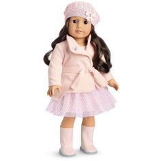 a doll with long hair wearing a pink coat and hat, standing in front of a white background