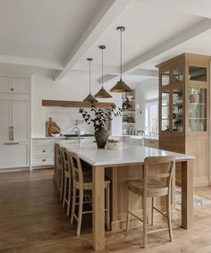 a large kitchen with an island in the middle and lots of counter space on one side