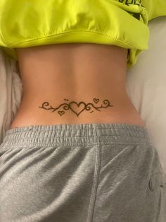 a woman with a heart tattoo on her stomach