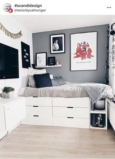 a bed room with a neatly made bed and some pictures on the wall above it