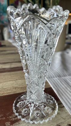 a glass vase sitting on top of a wooden table