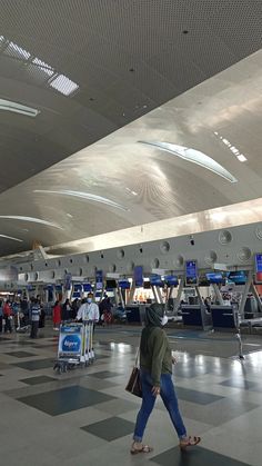 people are walking through an airport with luggage