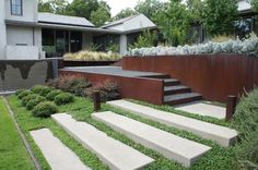 an outdoor garden with steps leading up to the house