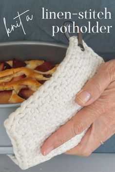 a person holding a dish towel over a bowl of food