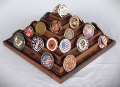 a wooden display case with many medals on it