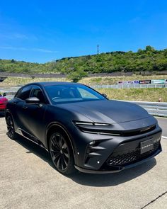 a black sports car is parked on the road