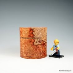 a wooden box with a lego figure next to it