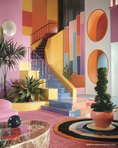 a living room filled with furniture and colorful walls