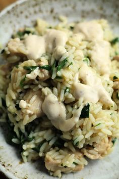 a white bowl filled with rice covered in gravy