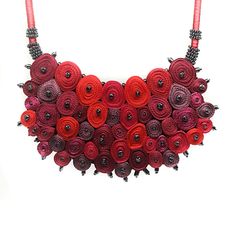 a necklace made out of red and black flowers