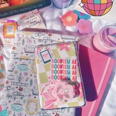 an assortment of items on a table including notebooks, pens and magnets with stickers