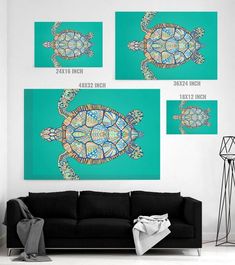 three pictures of sea turtles on a wall above a black couch in a living room