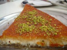 a slice of pizza with pistachio on top