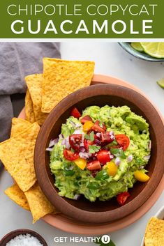 a bowl filled with guacamole surrounded by tortilla chips and salsa