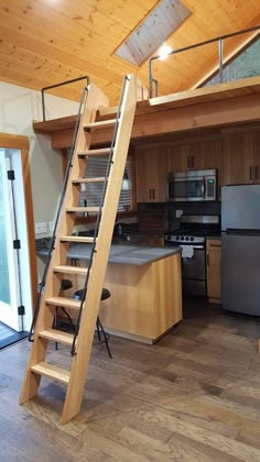 an open kitchen with stairs leading to the upper floor