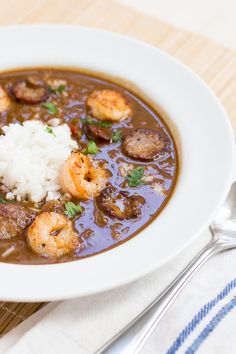 a white bowl filled with shrimp and rice