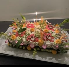 a cake with flowers and candles on it