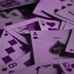 purple playing cards stacked on top of each other