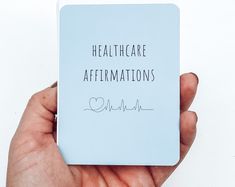 a hand holding a card that says healthcare affirmations