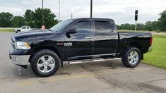 a black truck parked in a parking lot