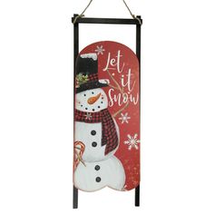 a snowman sign hanging from the side of a wall