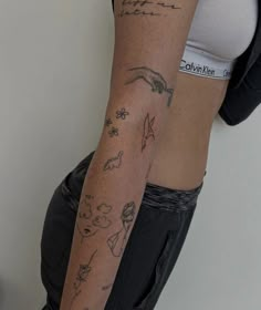 a woman's arm with tattoos on it