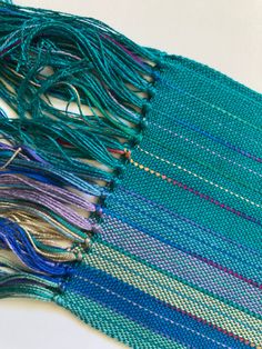 a close up of a piece of cloth with different colored threads and threads on it