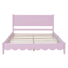 a pink bed frame with scalloped edges and wooden slatted headboard