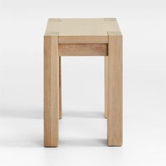 two wooden stools sitting side by side on a white surface, one is made out of wood and the other is made from plywood