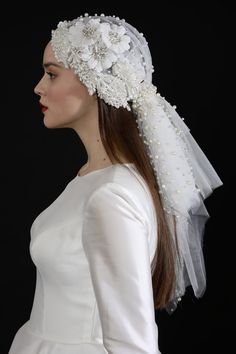 a woman wearing a veil with flowers on it