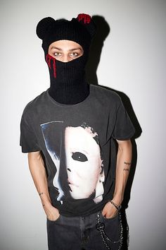 a man wearing a black mask and t - shirt