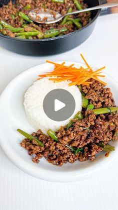 a plate with rice, meat and vegetables on it next to a skillet filled with sauce