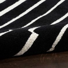 a black and white rug on top of a wooden table