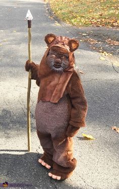 a person in a bear costume holding a pole